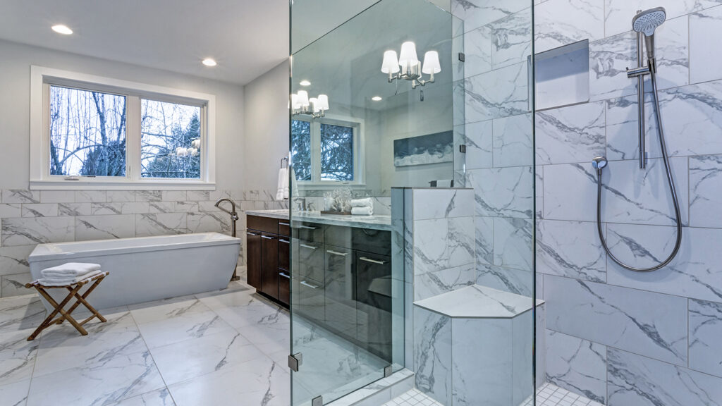 Incredible master bathroom with Carrara marble tile surround.