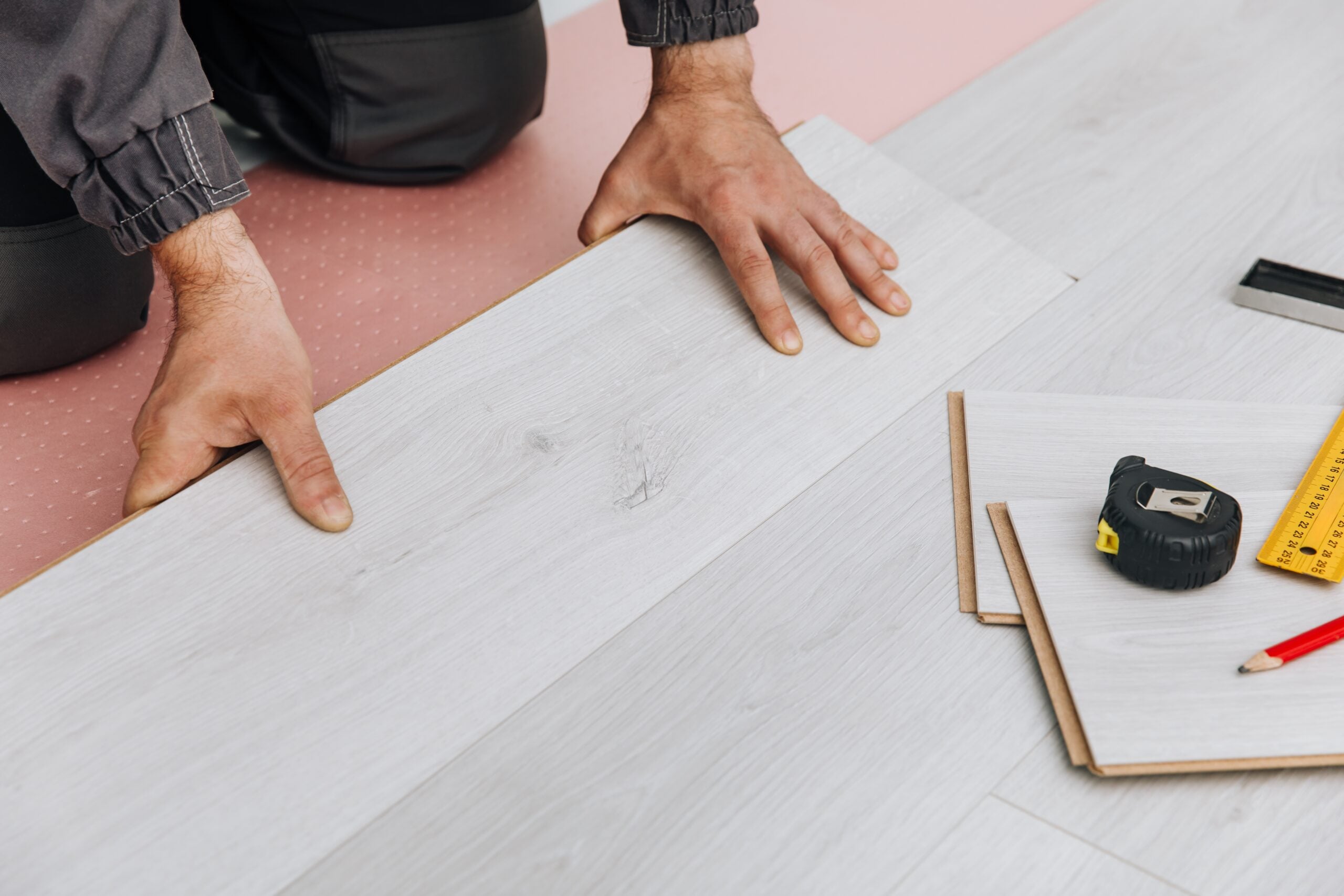 man-s-hands-installing-light-gray-laminate-floorin-2026-03-26-23-24-22-utc