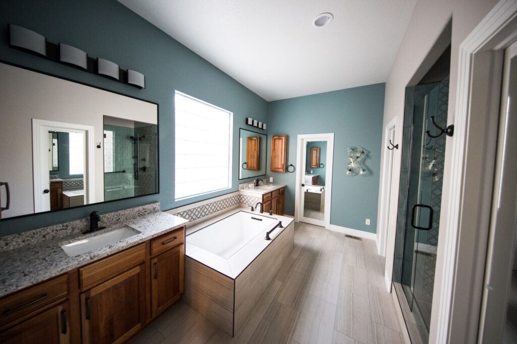 A Homeowner's Guide to PVC Free Vinyl Flooring in Central Florida 3 installer laying pvc free vinyl flooring in a Central Florida bathroom remodel