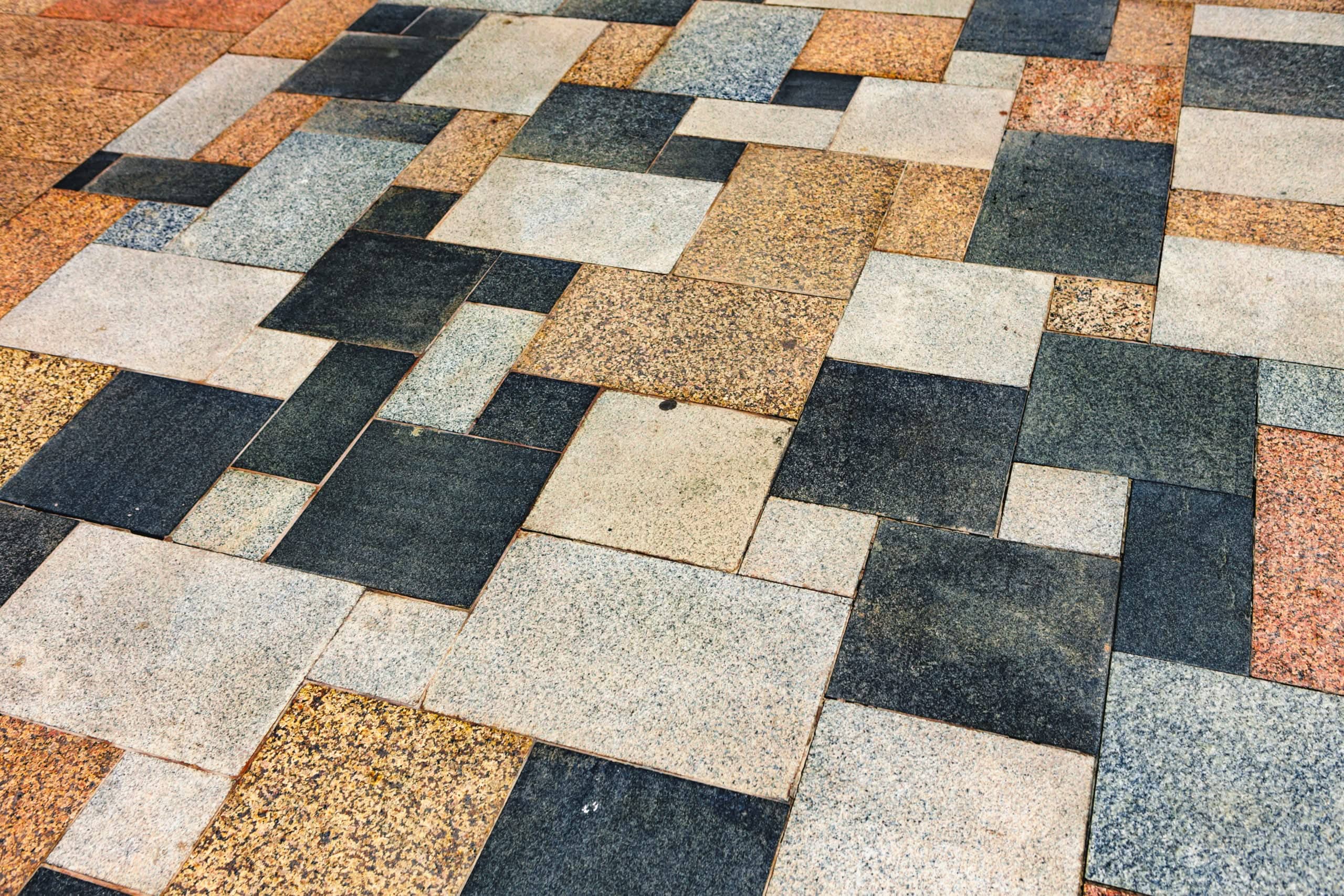 Textured stone and granite tiles installed in a multi-colored geometric pattern for outdoor tile installation in Ocala, FL.