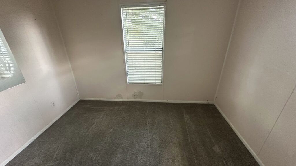 installer measuring a living room before flooring installation in Ocala